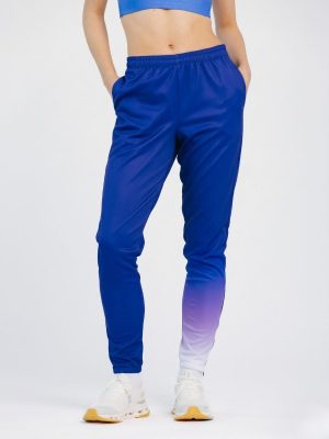 Front and side view of custom sublimation sportswear track pants for women, showing a purple-to-white gradient on one leg with a zipper detail.