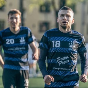 A soccer player wearing a custom-designed jersey with unique blue patterns