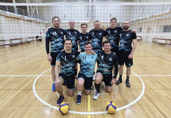 Dunalka volleyball team posing on court in custom sublimation jerseys