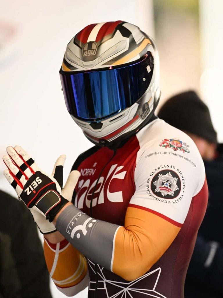Latvian national bobsleigh team athlete in custom sublimation sportswear racing suits