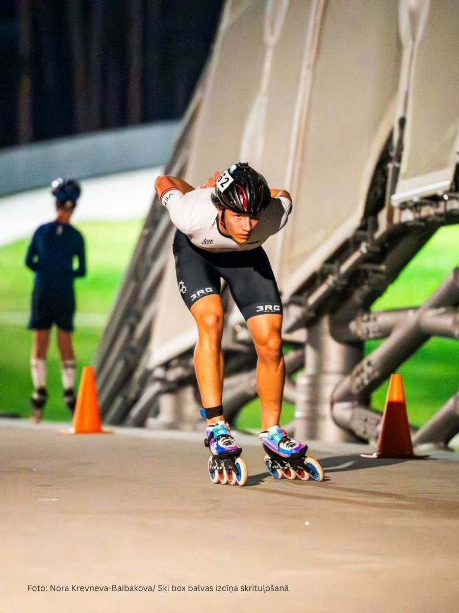 Professional inline speed skater in an aerodynamic tuck on a race track, wearing a custom "3RG" team skinsuit