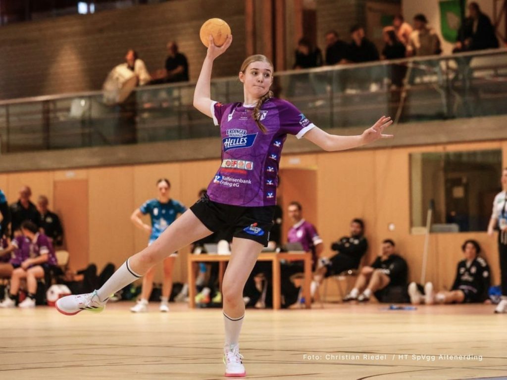 Action shot of a female SpVgg Altenerding handball player in a custom purple dye-sublimated jersey